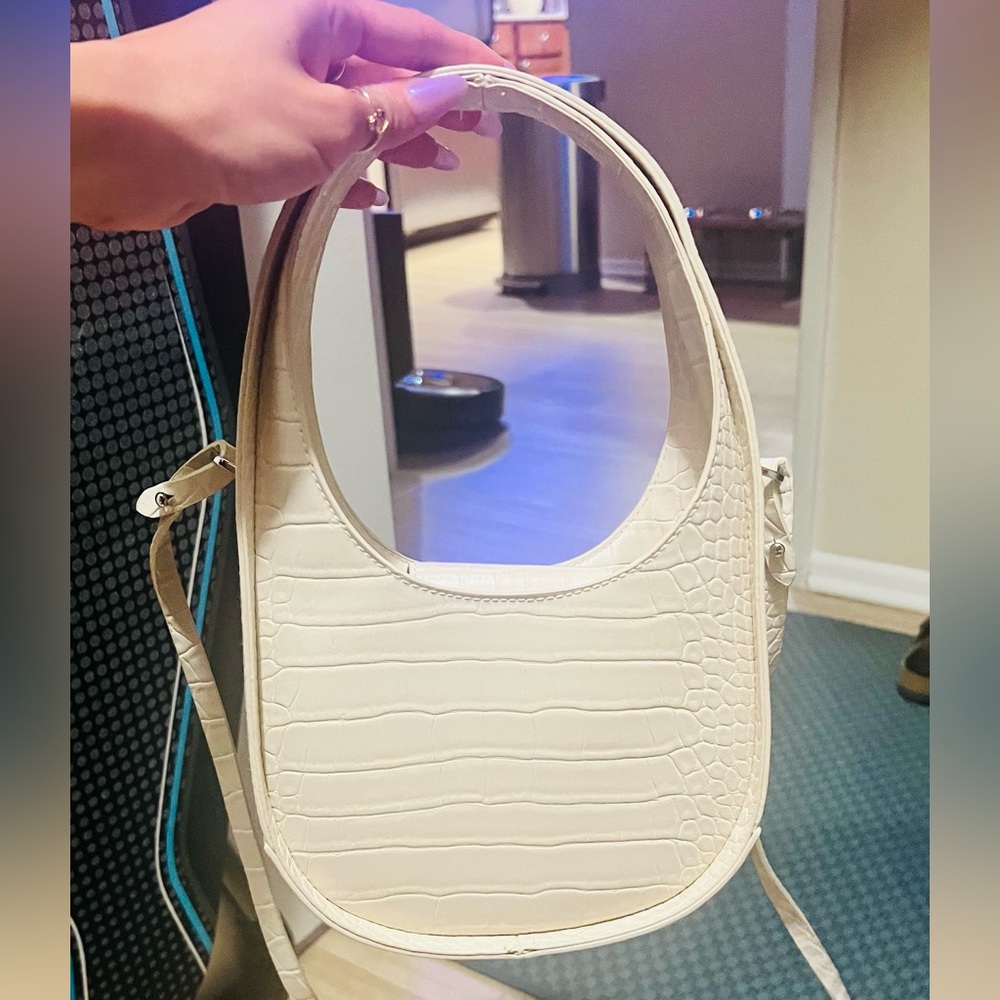 Off White color faux snake skin purse.